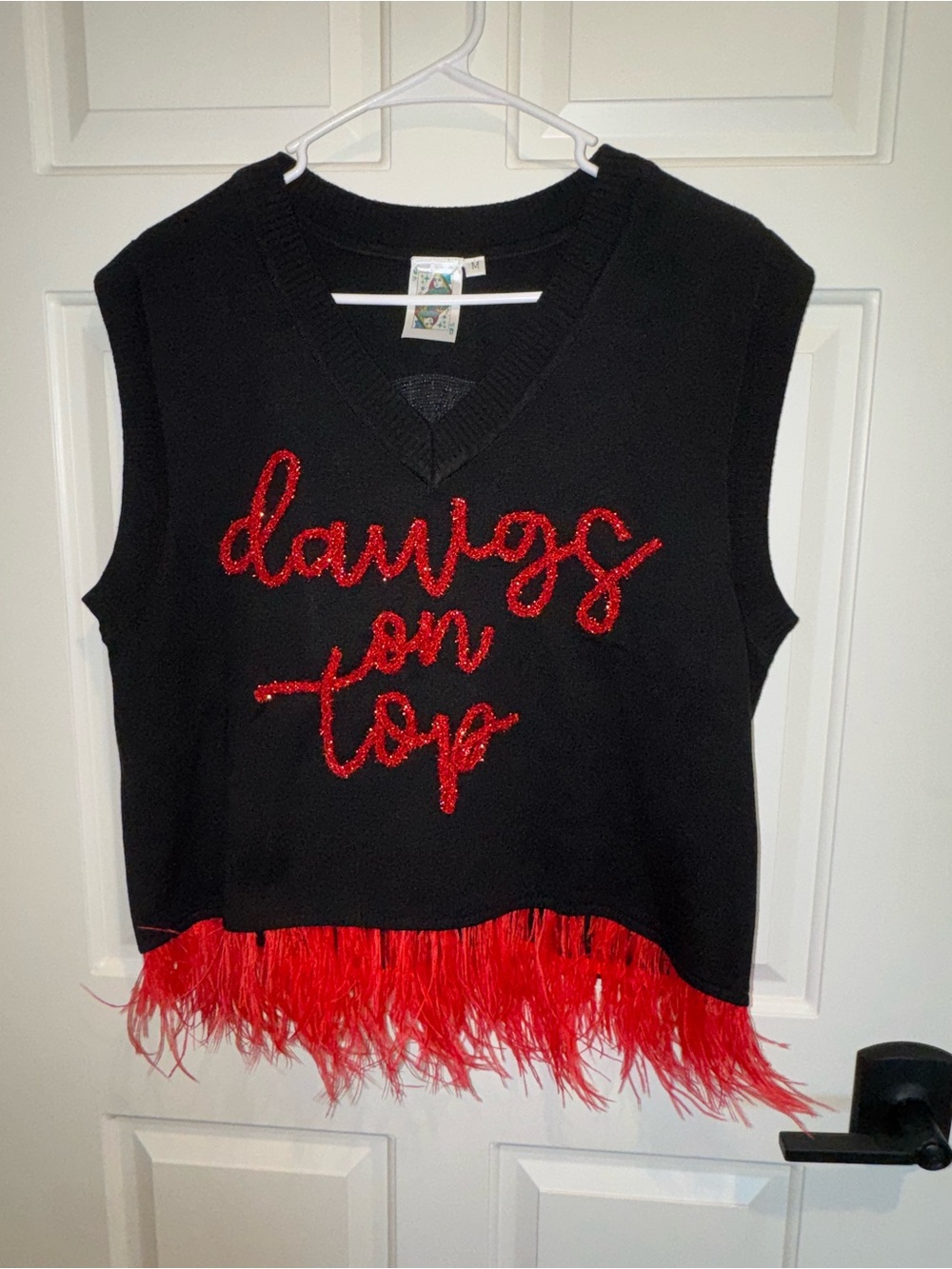 QUEEN OF SPARKLES Black Sleeveless Knit Top with Red Sequin Script & Feather Hem